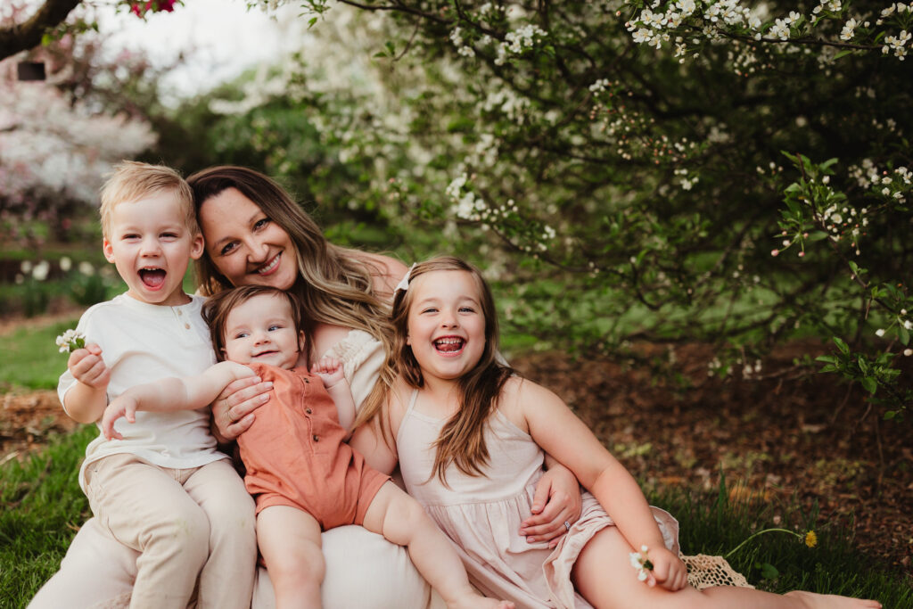 Madison Family Photographer, Liz Pachniak sitting and laughing with her three children.
