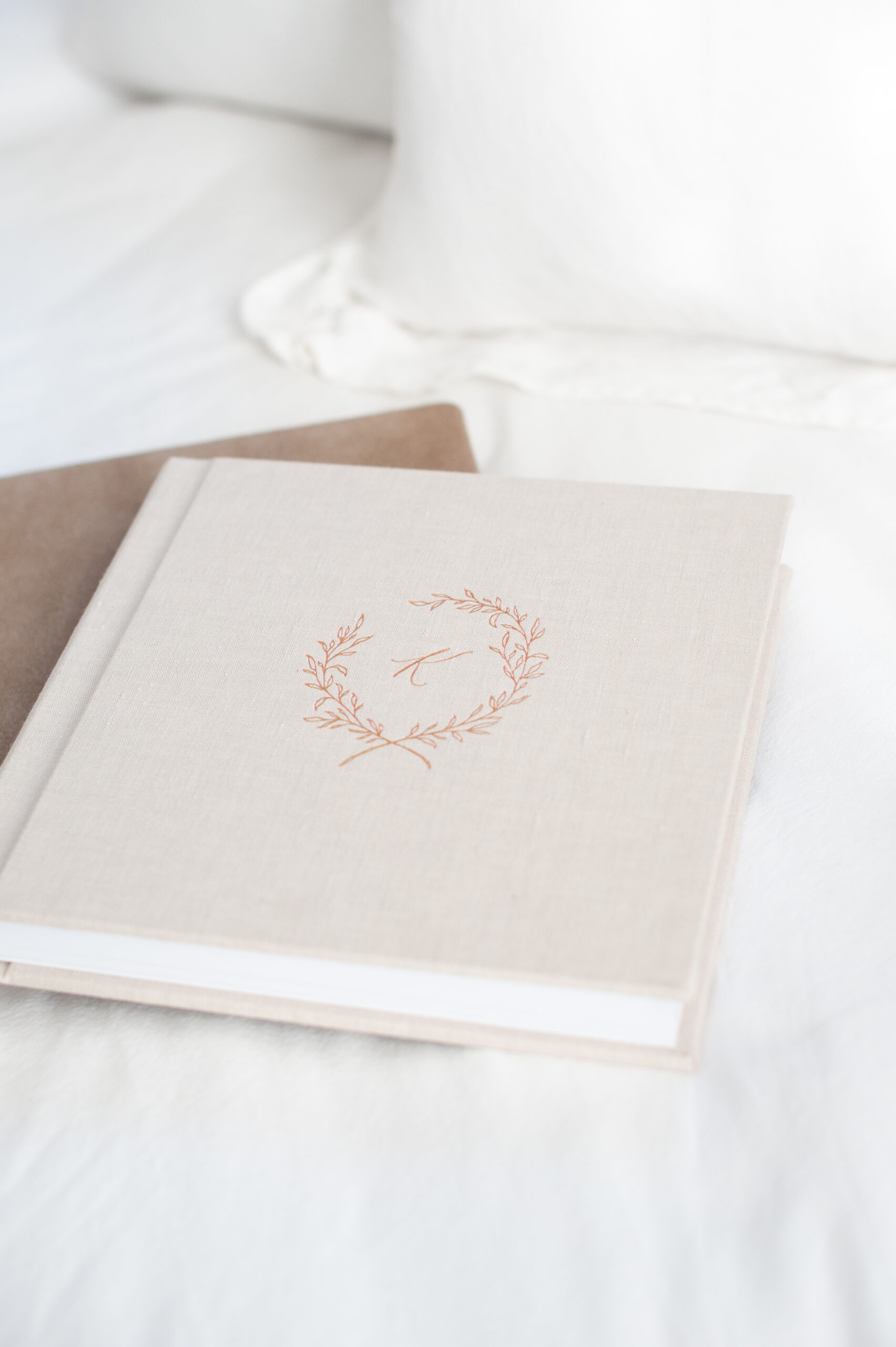 A photo of two beautiful linen albums stacked on top of each other as we explore the importance of printed photos.