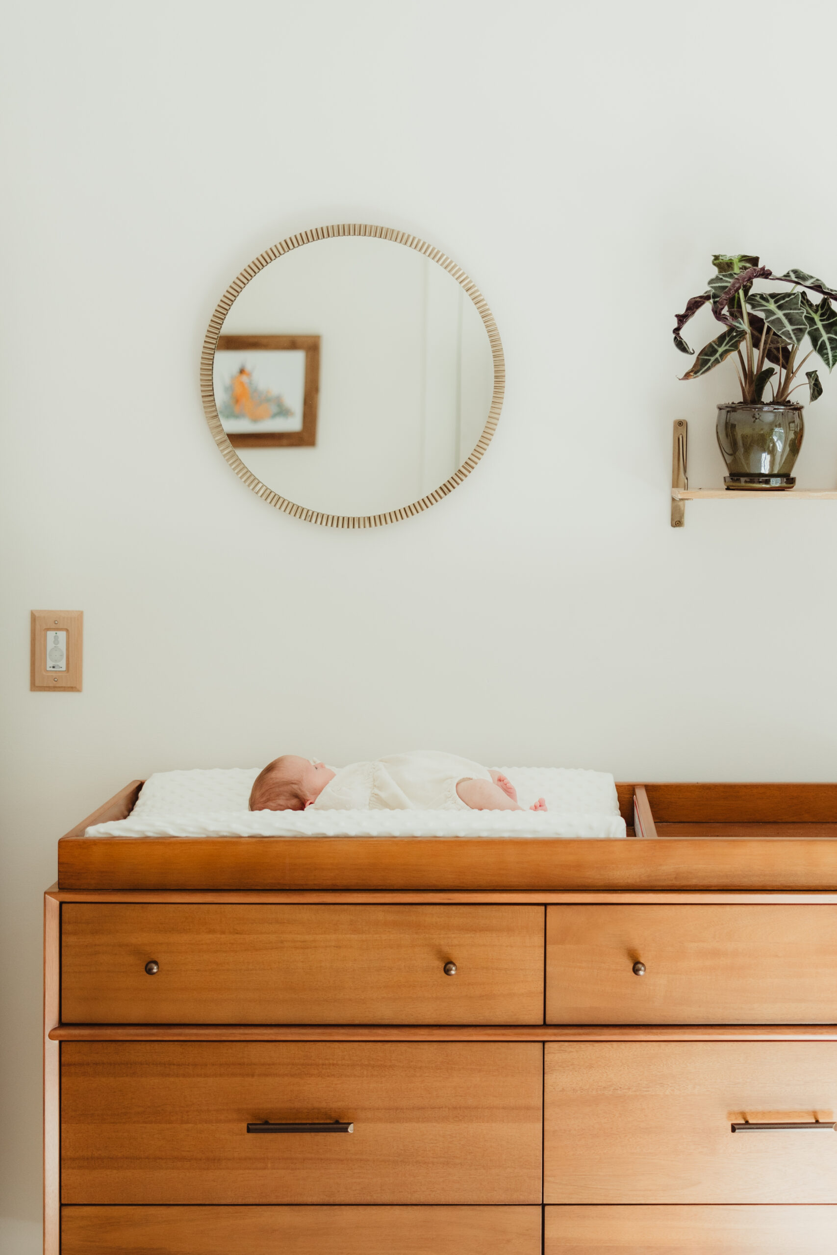 Newborn baby peacefully sleeping in a cozy nursery, captured by a Sun Prairie Newborn Photographer Elizabeth Pachniak Photography.