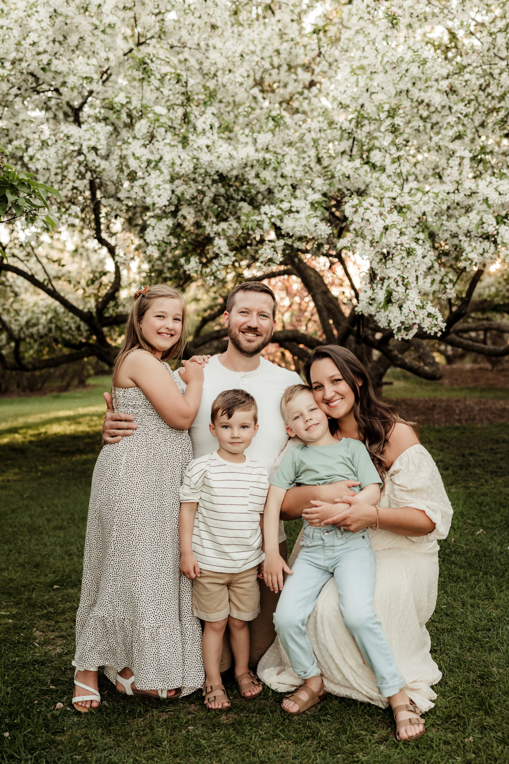 DSC01289 scaled Photo of Sun Prairie Newborn Photographer Liz and her family all smiling and looking at the camera.