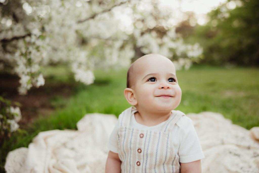 Family Photographer Madison WI 3330 A baby smiling off camera as an example of Lifestyle vs Portrait Photography in Madison WI.